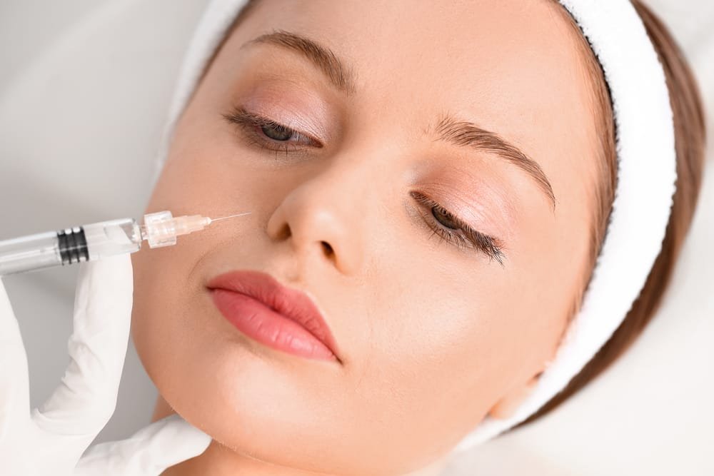 Young woman receiving filler injection  in beauty salon Dysport®2